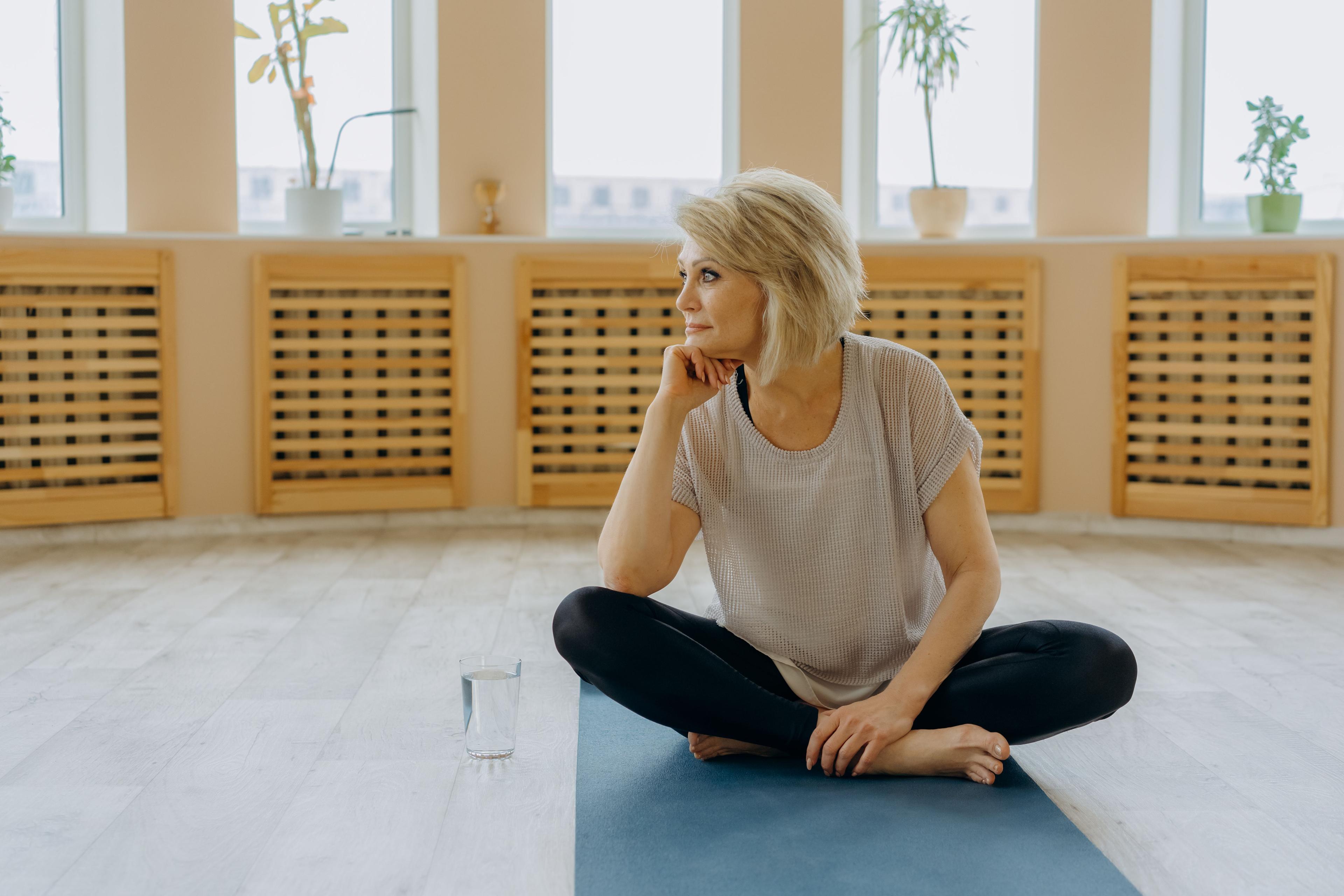 middle-aged woman comfortably on yoga position